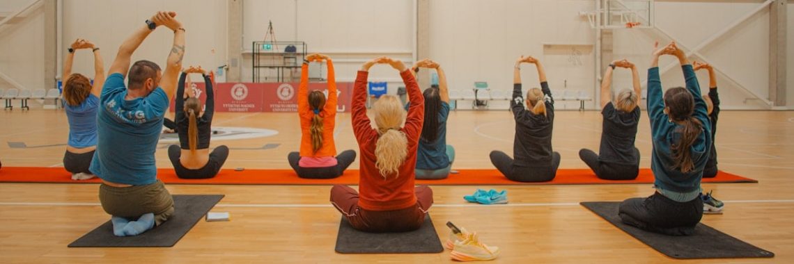 People are stretching during a yoga class.